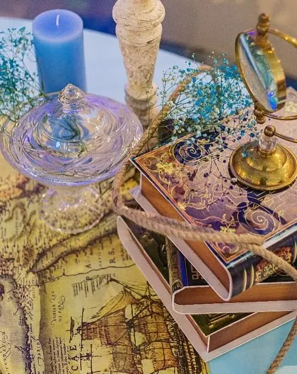 A detail shot of the table decor for the sailor party. A vintage-style map, a magnifying glass, and nautical rope tie the theme together beautifully.
