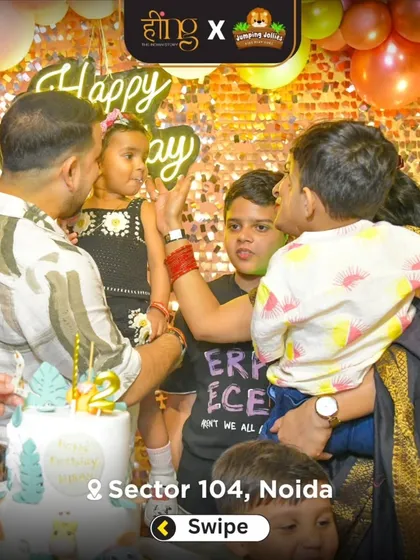 A candid moment of a family celebrating a 2nd birthday, with everyone focused on the birthday girl and her cake.