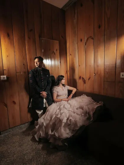 A dramatic, moody portrait from a Roka ceremony. We used focused lighting against a wood-paneled wall to create a sophisticated and timeless image of the couple.