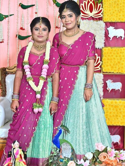 Nothing makes me happier than dressing sisters for their special moments. I designed these matching turquoise and purple Langa Voni outfits for a half saree function, ensuring they both looked coordinated yet unique.