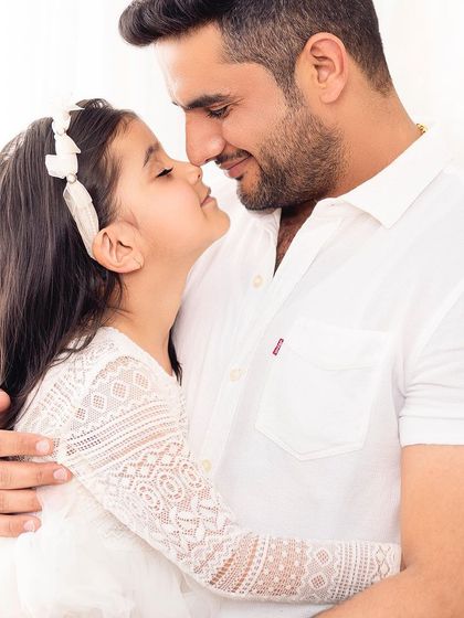 An adorable "eskimo kiss" between father and daughter. I love capturing these playful and affectionate interactions.