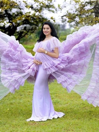 A magical butterfly pose with a lavender ruffled gown. The "wings" of the dress create a stunning, ethereal effect.