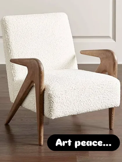 This accent chair is a piece of art, featuring sculpted wooden armrests and a comfortable bouclé fabric seat. It's perfect for clients who appreciate fine craftsmanship.