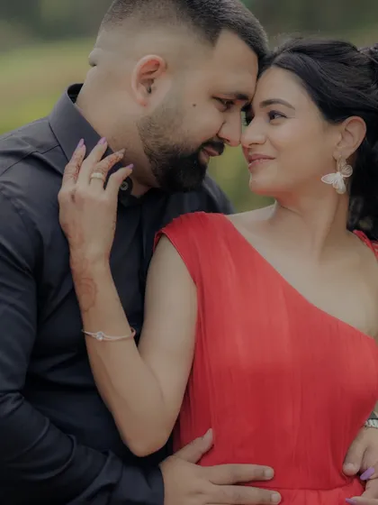 A close-up shot capturing the loving gaze between the couple. The woman's hand gently touching his face adds to the intimacy of this beautiful moment from their outdoor engagement shoot.