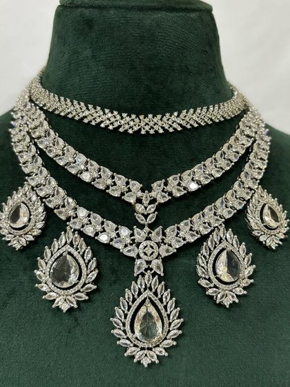 A close-up of a layered American diamond necklace, showing the intricate leaf-like patterns. This is a beautiful rental piece for any special occasion.