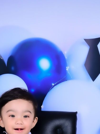 A close-up of a happy "Boss Baby" during his first birthday shoot.