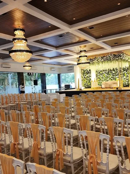 A wide view of the entire hall for the Green Vidhi ceremony, showing the grand stage and the extensive, neatly arranged guest seating.