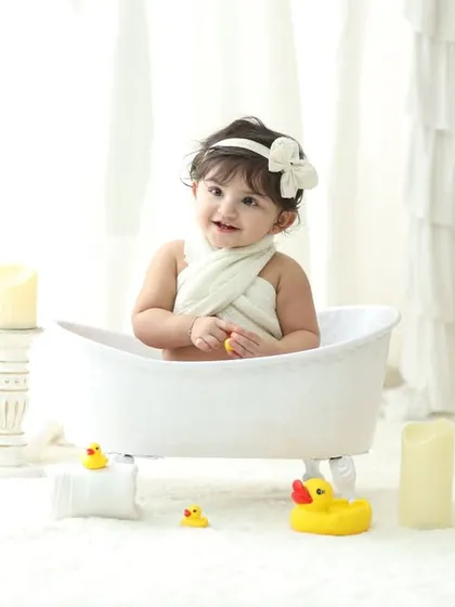 Our signature bathtub photoshoots are a favorite among parents and toddlers. This clean, all white setup with classic rubber ducks creates a simple yet adorable portrait that is timeless and full of fun.