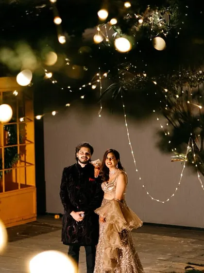 A cozy and romantic cocktail night setup. We used strings of fairy lights wrapped around trees to create a magical, starlit effect for the couple's portrait.