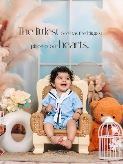 Dressed as a little sailor, this happy boy is all smiles for his first birthday. Our studio setups, like this nautical theme, are filled with charming details.