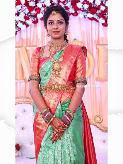 A closer look at the bride's reception outfit. The hand-embroidered blouse adds a touch of sparkle and sophistication to her traditional silk saree.