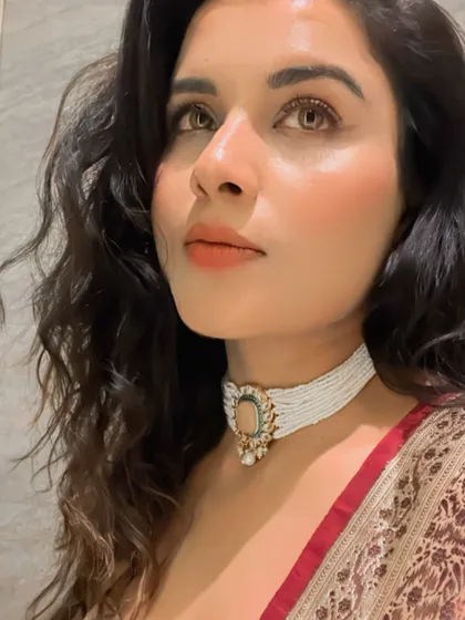 This is a perfect example of fusion styling. My client pairs a modern Indo-Western outfit with a stunning multi-layered pearl choker, creating a chic and sophisticated look for a Diwali party.