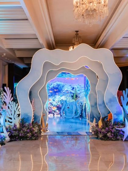 The entrance to Anvika's 'Under the Sea' party was a breathtaking portal to another world. The layered, wave-like arches and cool blue lighting immediately immersed guests in the ocean theme.