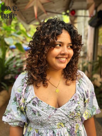 The perfect smile to go with a perfect haircut. This client's curly bob is full of life and personality.