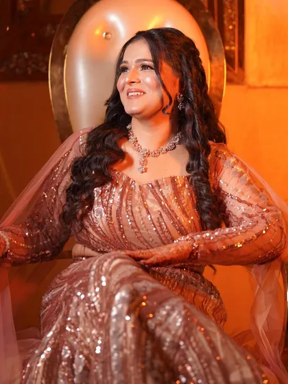A happy moment captured. Her smile and the radiant makeup light up the frame.