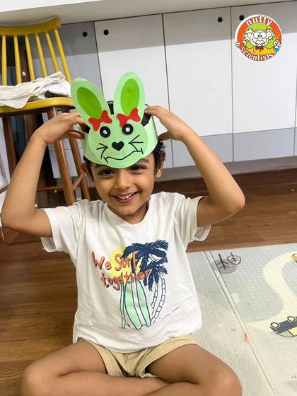 The joy is contagious. This young boy is having a blast with the bunny ears he crafted himself during our camp.