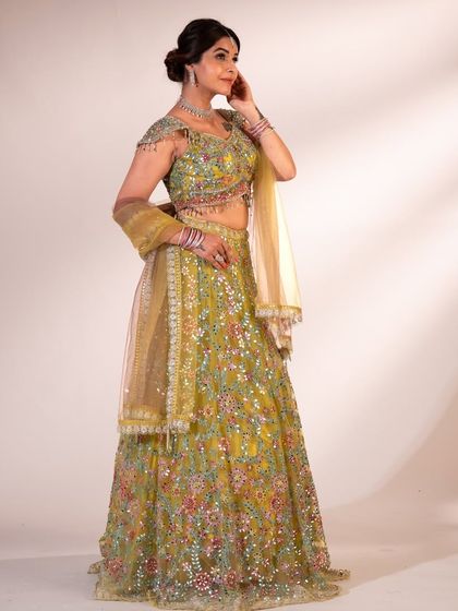 Another look at the green floral lehenga, a perfect choice for wedding guests who want to stand out in a crowd.