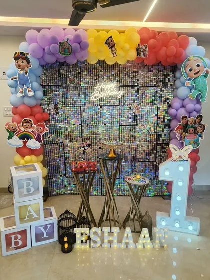 Another angle of the Cocomelon party decor, highlighting the light-up number '1', 'B-A-B-Y' blocks, and personalized name display.