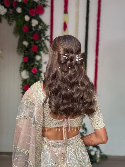 A wider shot of the half-up bow hairstyle, showing how it looks with the full outfit. The style adds a touch of whimsy and romance to this stunning engagement look.