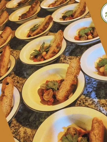 Plates lined up and ready to be served at one of our exclusive dining events. Each dish is prepared with care and attention to detail.