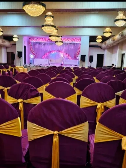 Seating arrangement at Palm Beach banquet hall. The purple chair covers with gold ribbons add a touch of royalty to the decor.