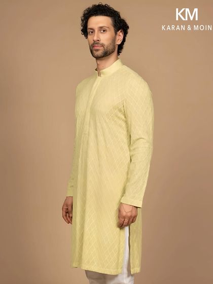 A modern classic in quiet hues. This pastel woven kurta is tailored in a fine-textured fabric with a subtle diamond pattern. The clean mandarin collar and concealed placket make it perfect for daylight rituals and moments that matter.