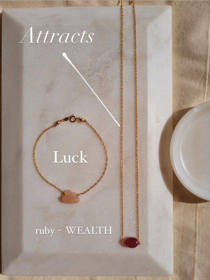 This set is all about attracting luck and wealth. The Peach Moonstone cloud bracelet brings good fortune, while the Ruby choker is a powerful stone for attracting money.