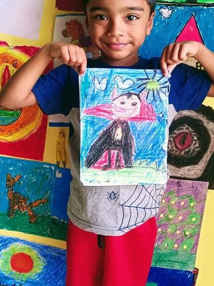 A happy student showing off his cool Dracula drawing. We love it when kids draw their favourite characters.