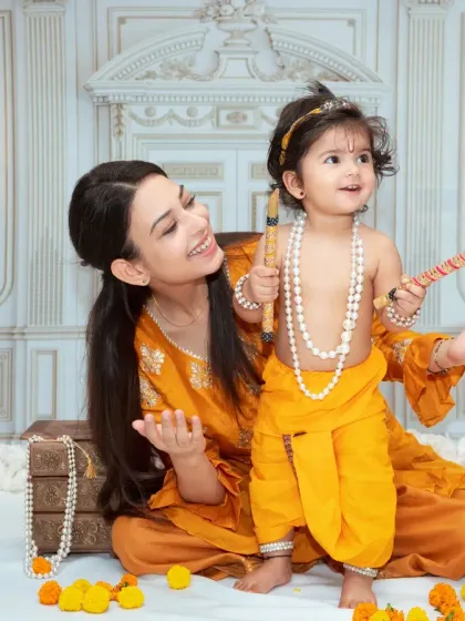 A mother and child enjoying the Janmashtami setup. These sessions are a wonderful way to introduce your child to cultural traditions.
