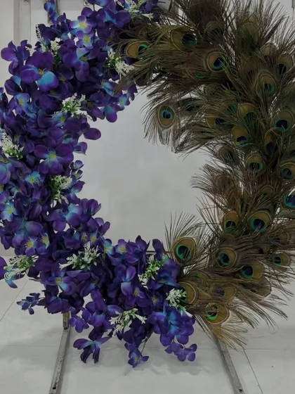 For a touch of royalty and something truly unique, I designed this wreath combining beautiful purple orchids with iridescent peacock feathers.
