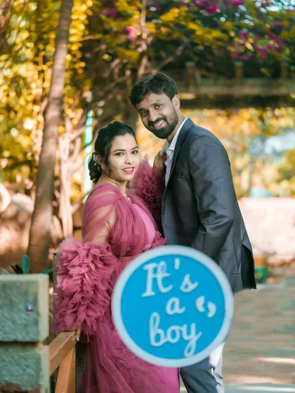 A sweet gender reveal moment captured during an outdoor maternity shoot. The "It's a boy" sign adds a personal touch to their story.
