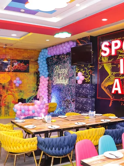 Another view of our versatile dining space, decorated for a party with a sequin backdrop and balloon columns. The layout can be customized for your group size.