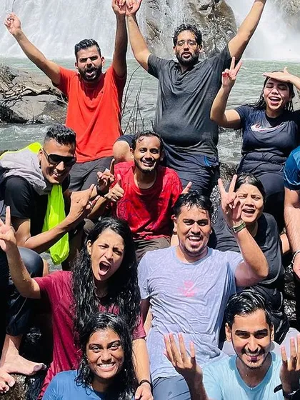 A happy group of trekkers enjoying a dip in a waterfall. Our trips are about finding joy and refreshment in nature's playgrounds.