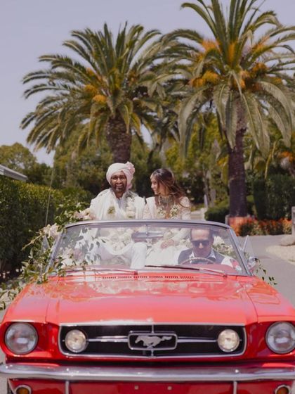 The happy couple making their grand entrance in a vintage red Mustang. It's wonderful to see the vibrant, joyful moments that my stationery helps to announce.