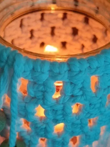This macrame-wrapped jar, lit from within, creates a stunning lantern effect. It's a perfect, cozy addition to your Diwali decorations.