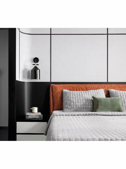 A bedroom should be a personal sanctuary. This master bedroom, part of our 'Reflections' project, is discovered through an inconspicuous door, creating an element of surprise. The design uses a masculine palette of black, white, and grey, with a tan leather bed providing a warm, stark contrast, all set against the backdrop of the sea.
