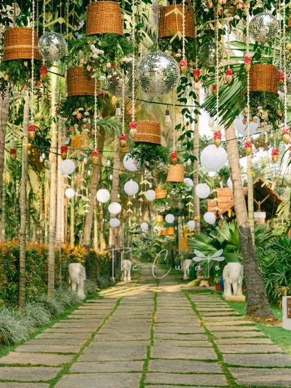 The pathway decor seen from a different perspective, highlighting the density and richness of the hanging elements against the green backdrop.
