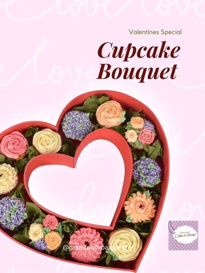 Another view of the heart-shaped cupcake bouquet box. It features a mix of regular and mini cupcakes piped to look like different flowers.