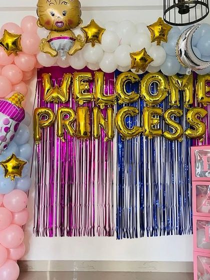 Make her feel like royalty with this "Welcome Princess" decoration. It features a shiny foil curtain backdrop in pink and blue, a balloon arch, and "BABY" boxes. I can customize the colors and message for you.