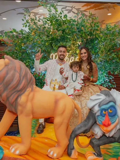 The birthday boy and his family posing on the jungle-themed stage. Our detailed props and backdrops create the perfect setting for memorable family photos.