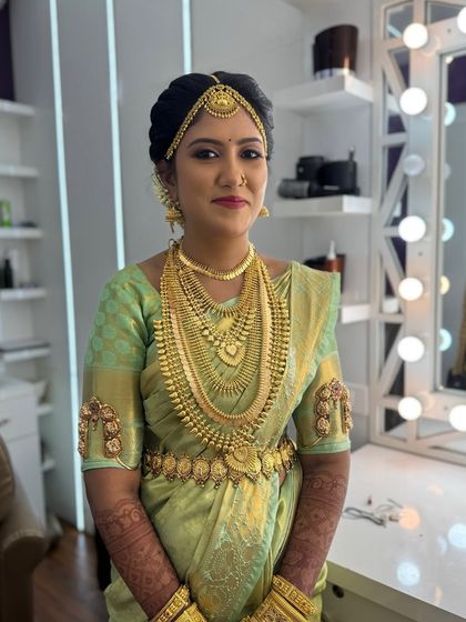 Harina looking stunning in her full Muhurtham attire. The makeup is bold and classic, with a bright red lip that stands out against her green saree and gold jewellery.