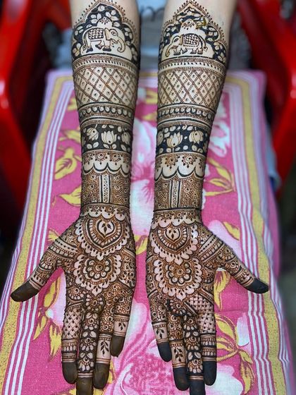 The same beautiful elephant and lotus design, showing the rich, dark stain of the henna.