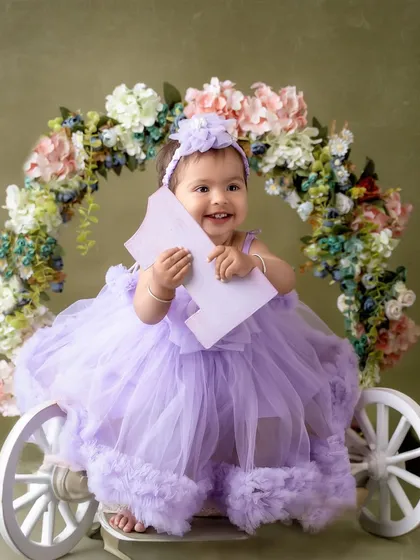 A happy smile from her floral carriage. This little princess is celebrating turning one in style.