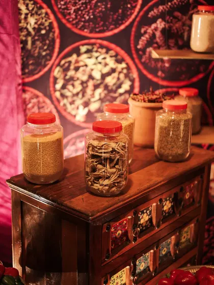 A small wooden chest with painted drawers, used to display jars of whole spices. It's these curated props that help build the story and make a themed event feel genuine.