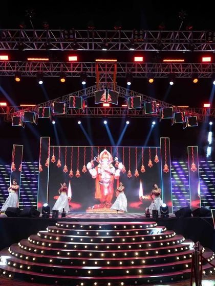 A divine start to the Sangeet night with a performance dedicated to Lord Ganesha, set against a massive LED backdrop. I blend tradition with modern production seamlessly.