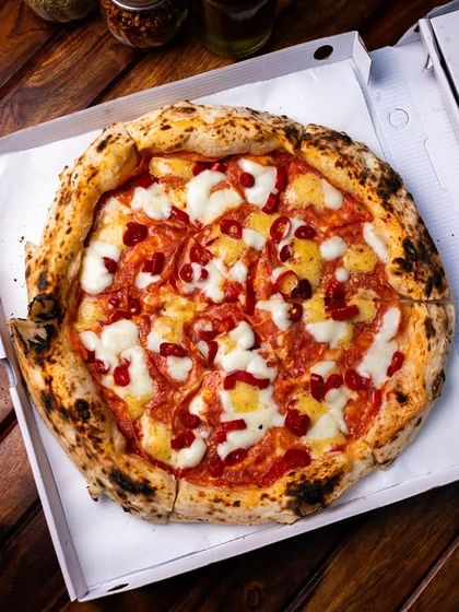 A classic mozzarella pizza, boxed up and ready for delivery from our Amar Colony outlet.