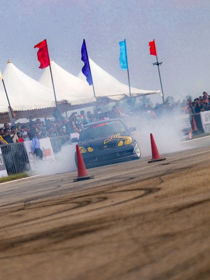 The Lexus drift car in action, sliding past the crowd with tires smoking. We ensure the action is up close and personal for an unforgettable fan experience.
