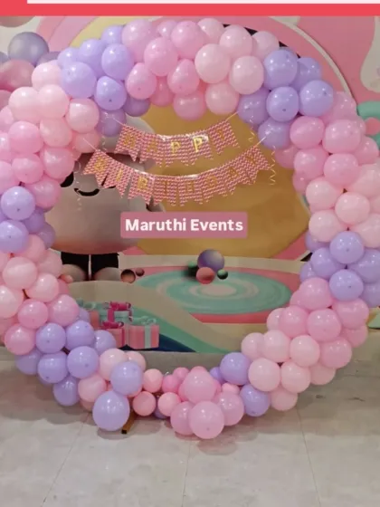 A simple but beautiful circular balloon arch in pastel pink and purple. This shows how a basic setup can still be very effective and pretty.