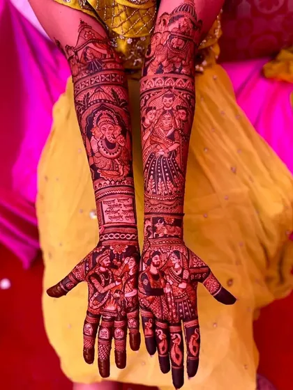 A vibrant design with deep red tones, featuring portraits of Ganesha, a bride, and a couple, all woven into a single narrative.