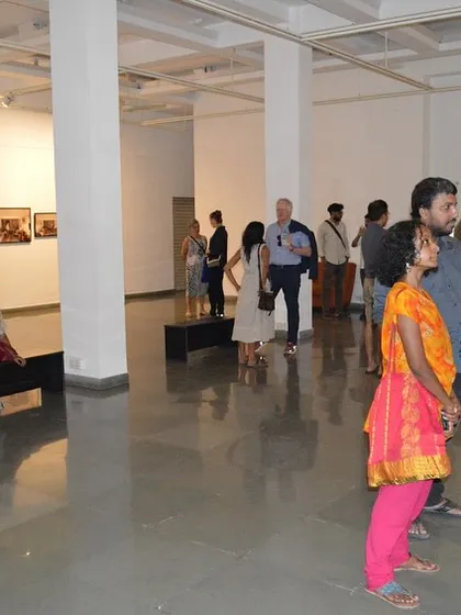 A wide shot of the gallery space during the opening night of Sandeep T K's exhibition.
